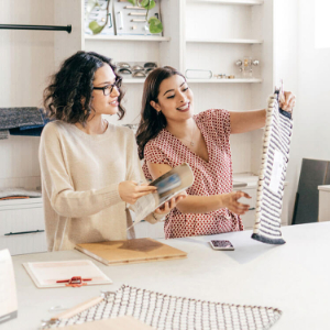 two business owners looking at a new garment.