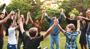 a group of people holding hands in a circle