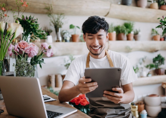 a small business owner viewing a tablet