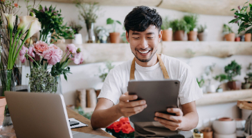 a small business owner looking at their tablet