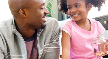 a father and daughter smiling