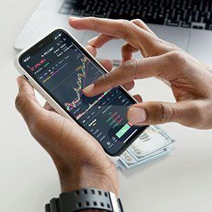 A man looking at rates on a smartphone