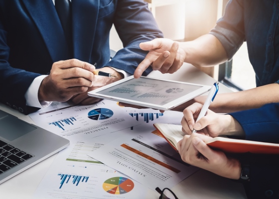 a group of people discussing financial documents