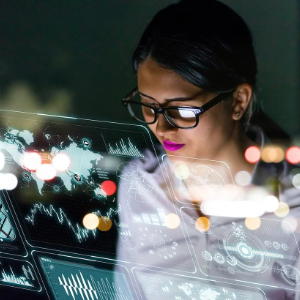 a lady wearing glasses viewing a holographic charts