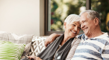 an elderly couple embracing each other