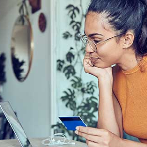 a woman holding her credit/debit card