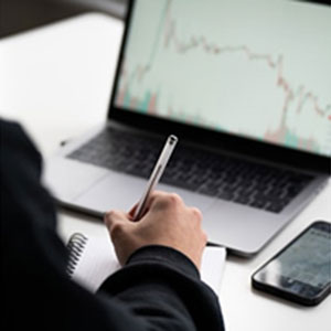 Businessman at a laptop looking at rates