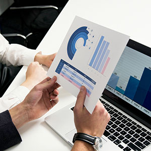 Coworkers looking at a chart at a laptop