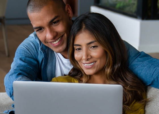 a couple looking at their laptop computer