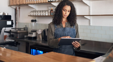 a business owner looking at her tablet