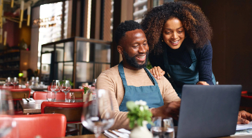 two business owners checking their finances