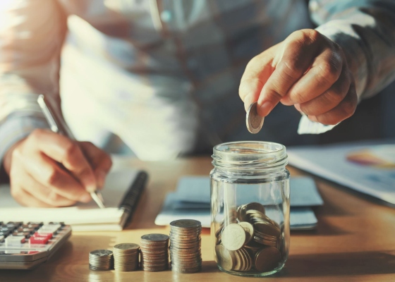 a business owner stacking coins in a jar