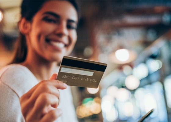 a woman paying with her debit/credit card
